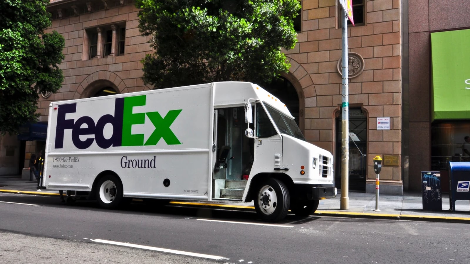 FedEx delivery vehicle operating on a city street.