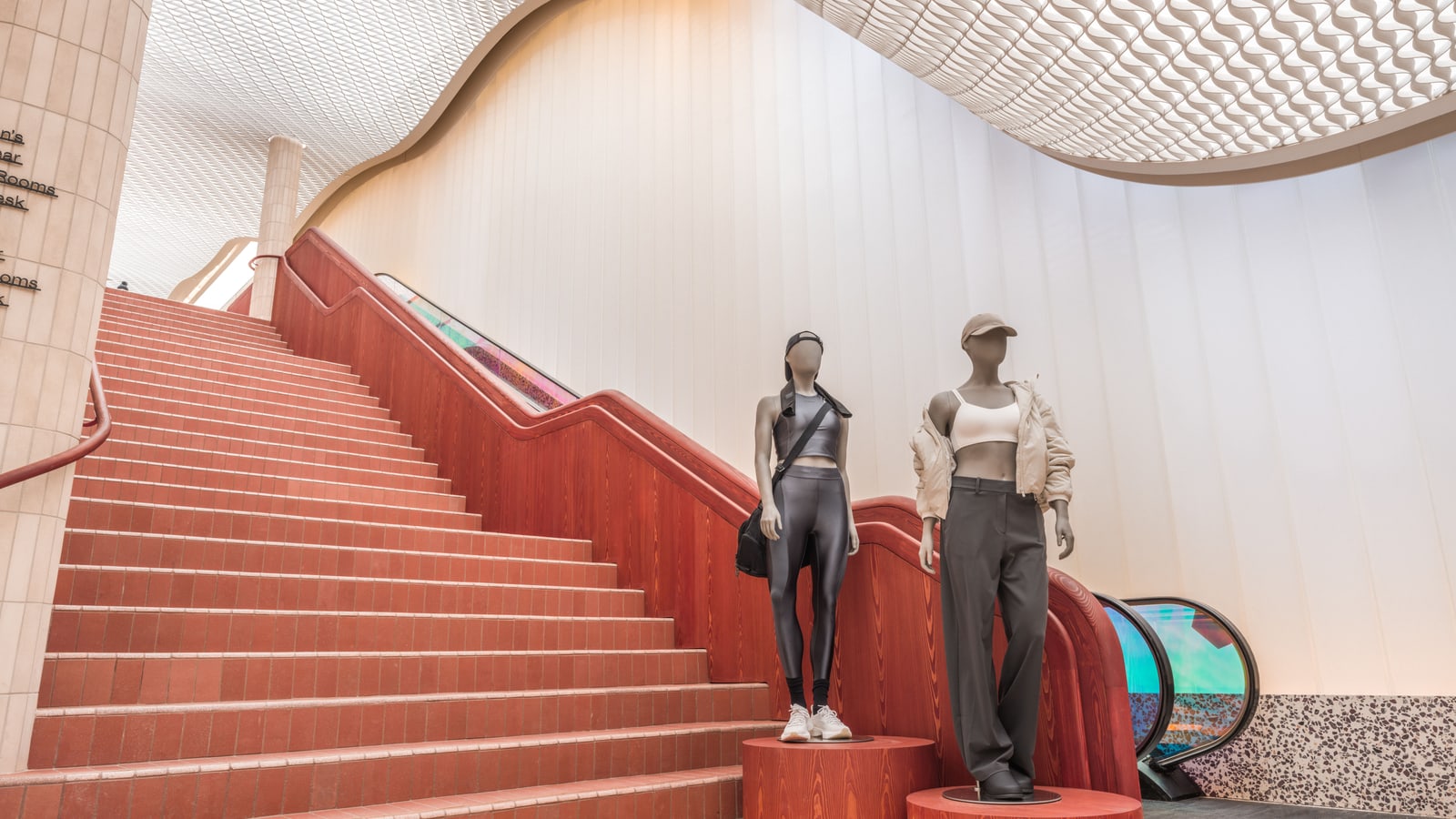 Interior of the lululemon SoHo flagship with apparel fixtures, customer circulation, and hospitality zones.