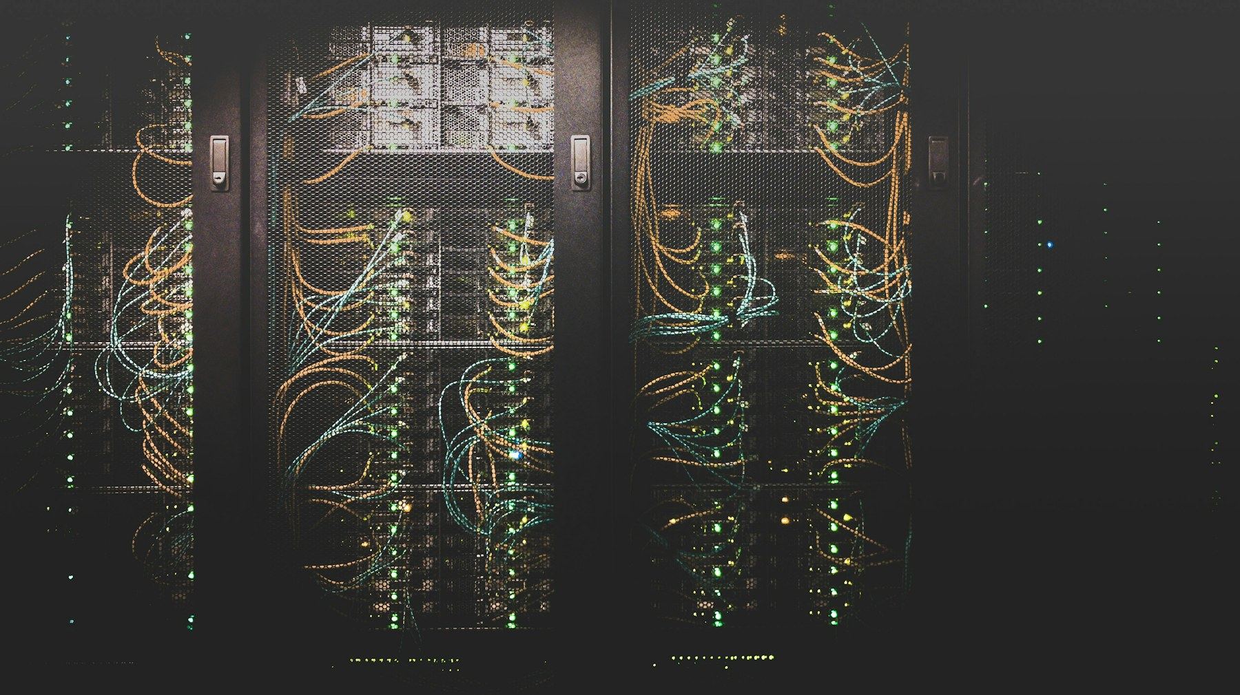 Rows of illuminated network servers representing the infrastructure behind payment switching and security.