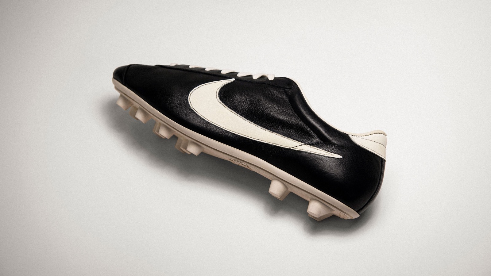 Official Nike archive photograph of the original black football boot carrying an early white Swoosh.