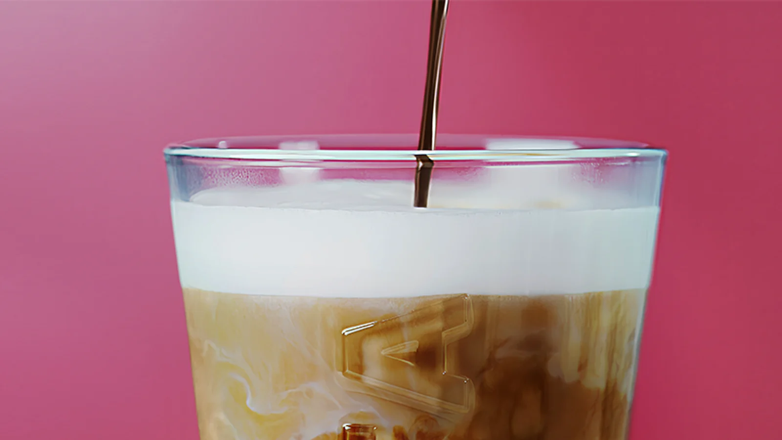 Layered Costa iced latte against a burgundy background.