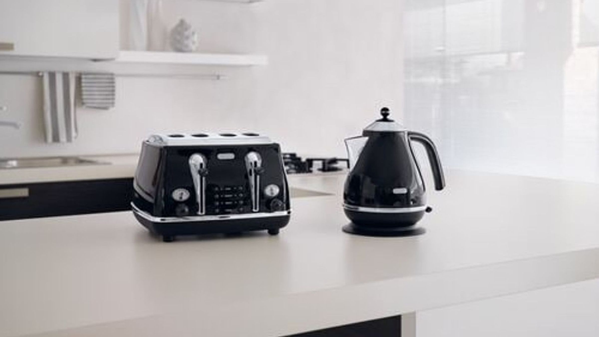 DeLonghi kitchen appliances on a clean counter.