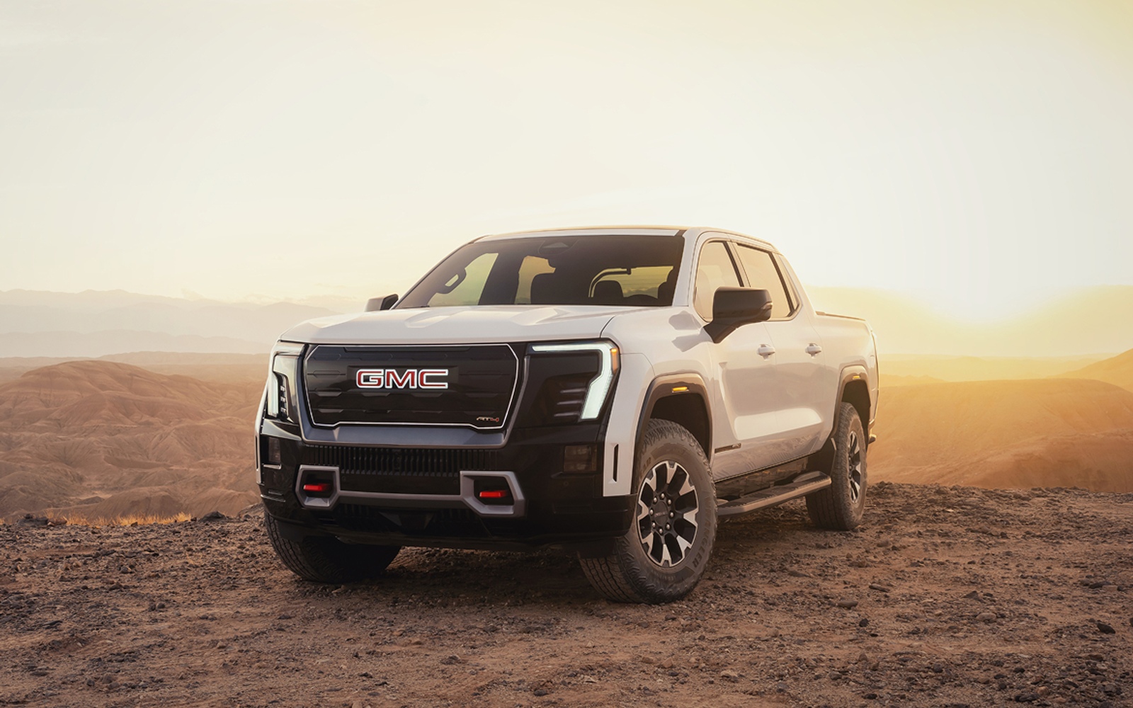GMC truck photographed in an official General Motors brand card.