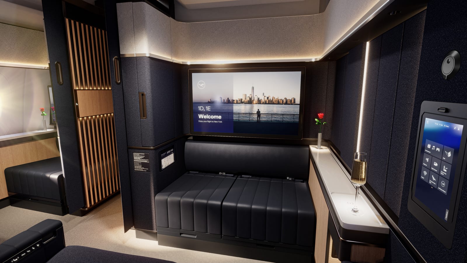 Lufthansa Allegris Suite Plus with enclosed seating, large display, navy surfaces, and warm wood details.