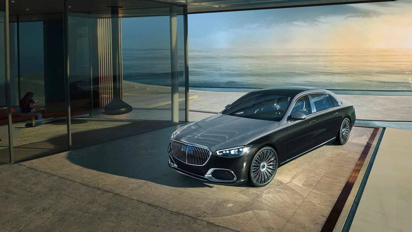 Official Mercedes-Maybach S-Class editorial photograph beside modern oceanfront architecture.
