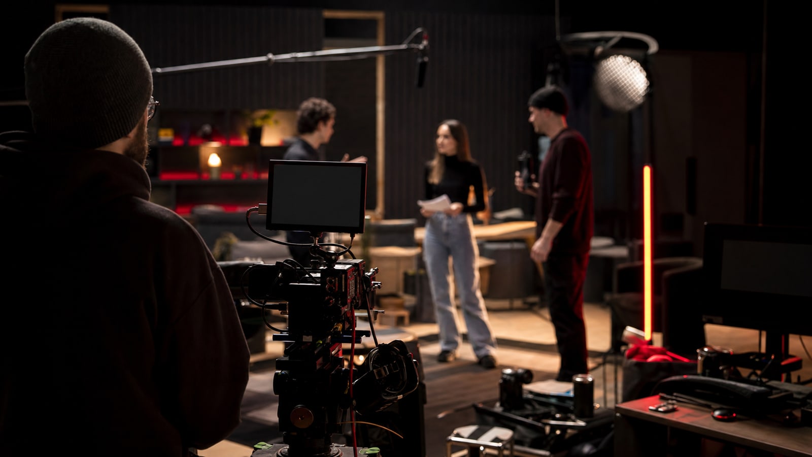 Modern streaming production set with camera and crew.