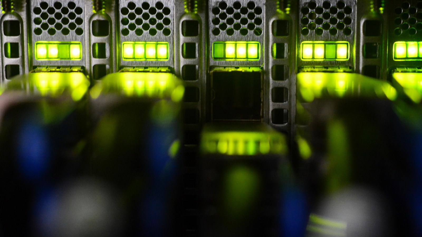 Server rack detail with green-lit data center equipment.
