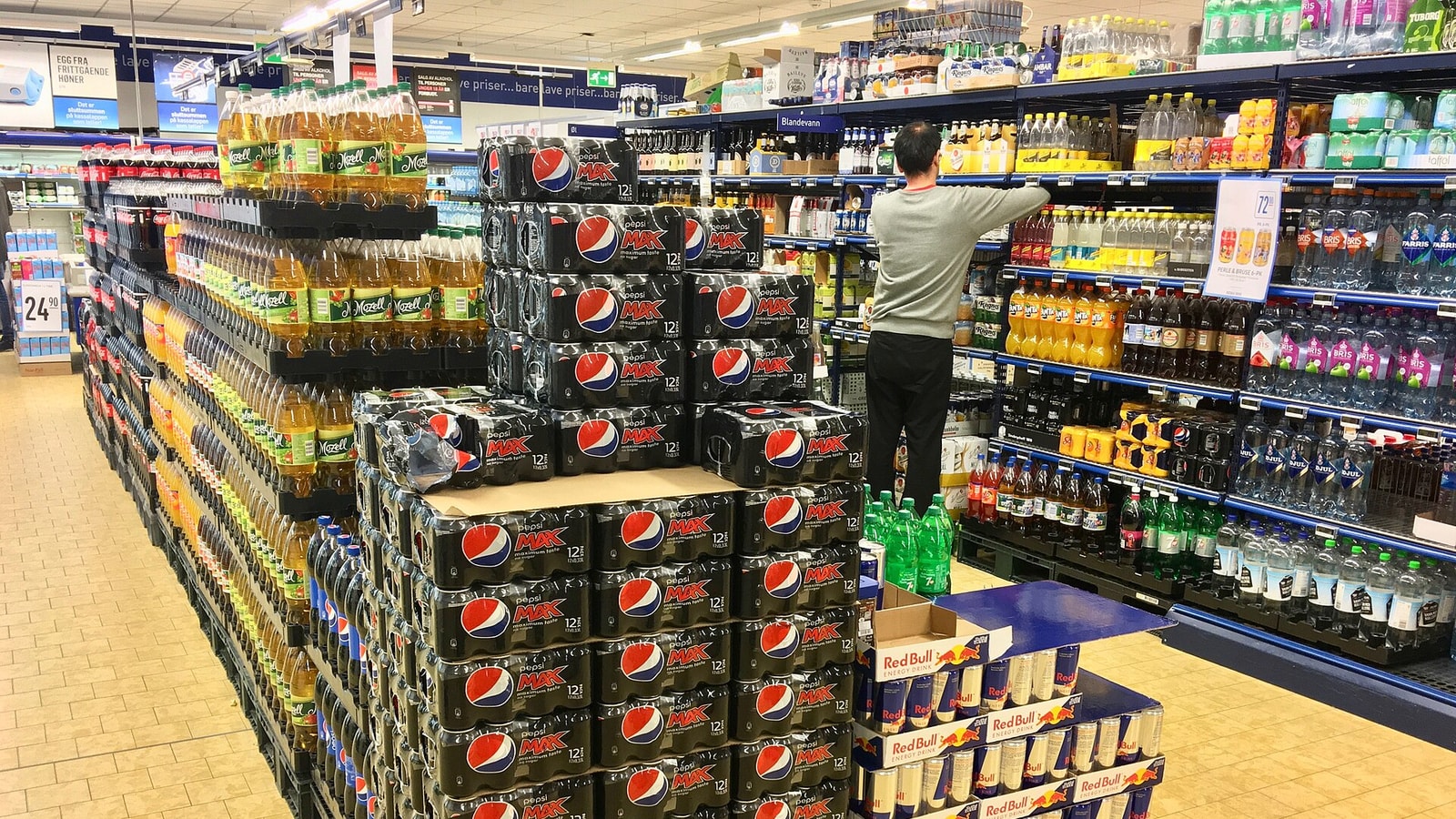 Pepsi packages for sale on a supermarket shelf.