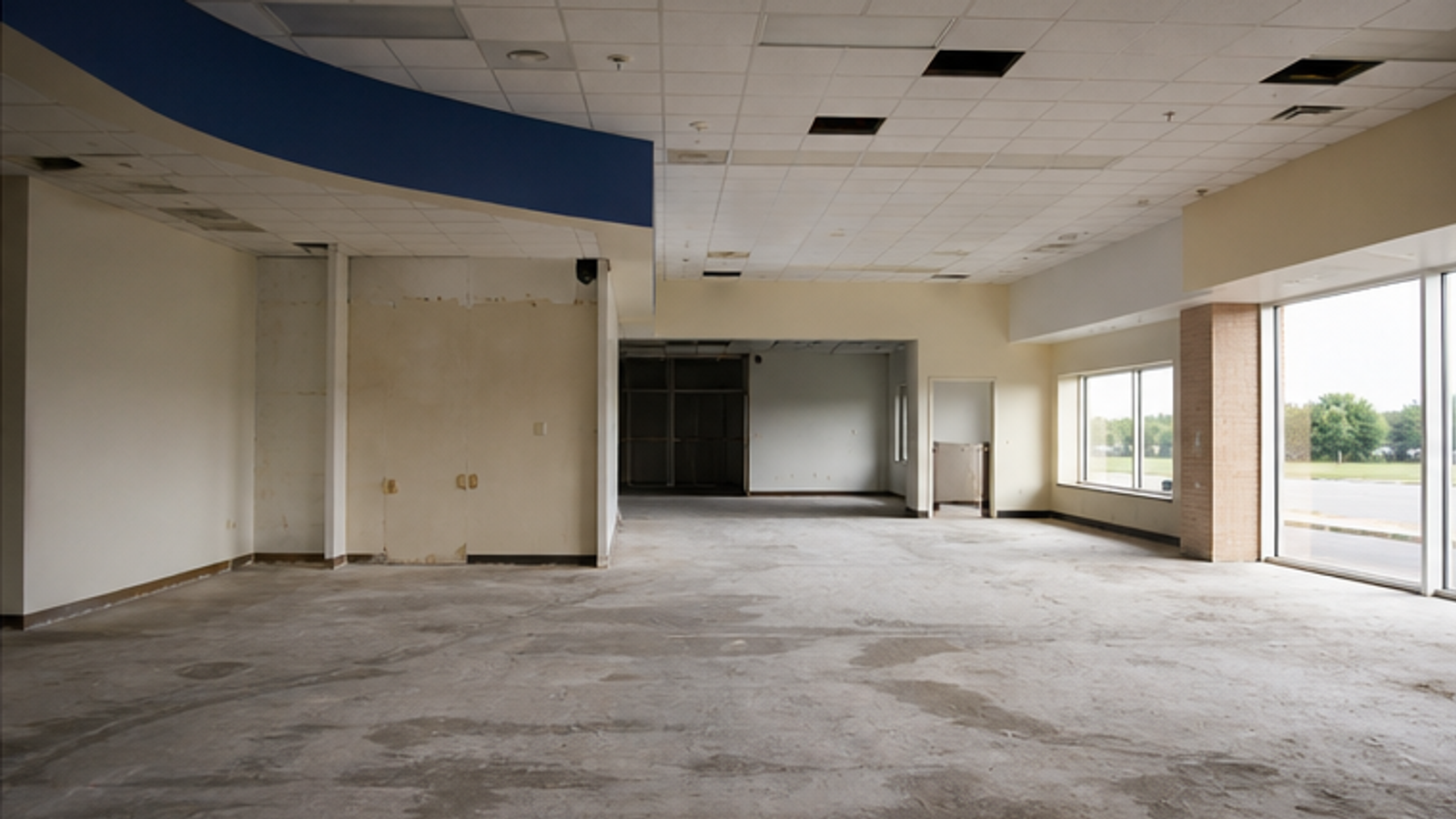 An emptied former pharmacy retail shell after fixtures were removed.
