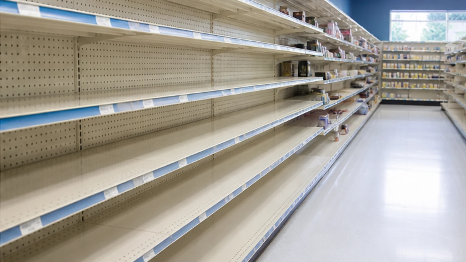 Long pharmacy retail shelves with severe stock gaps.
