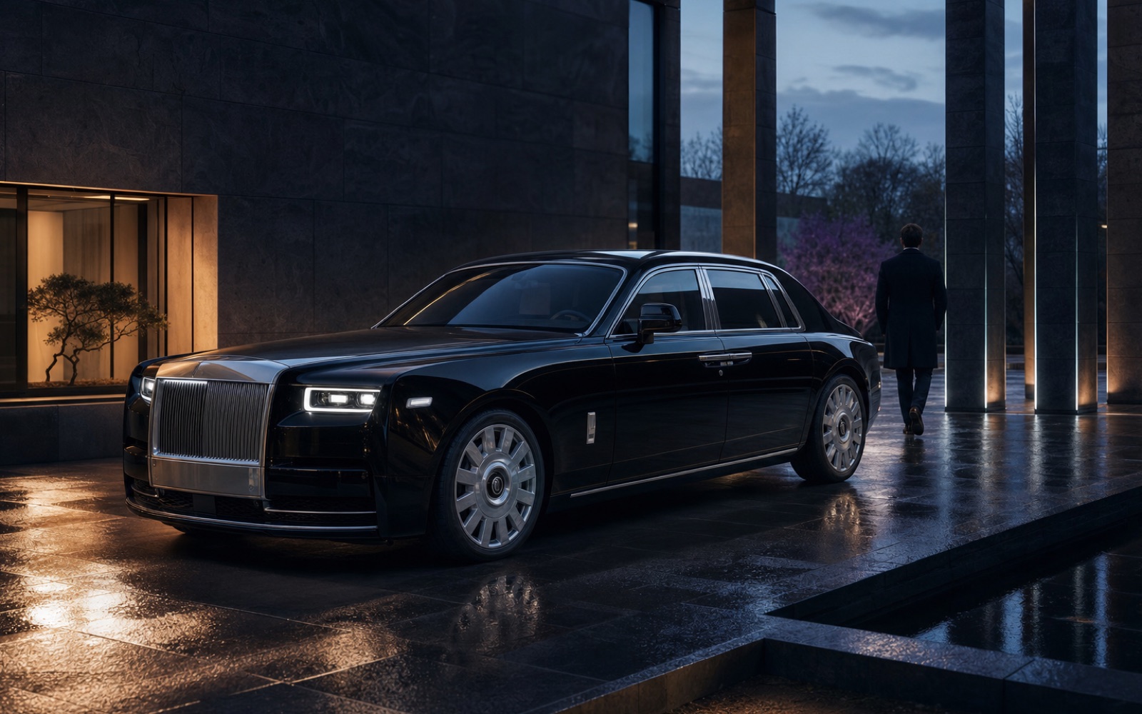 A black long-wheelbase luxury saloon in a quiet arrival court.