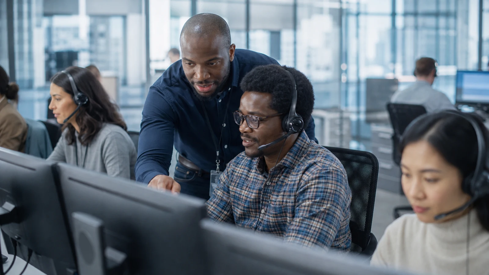 A service operations team coordinates customer support across workstations.