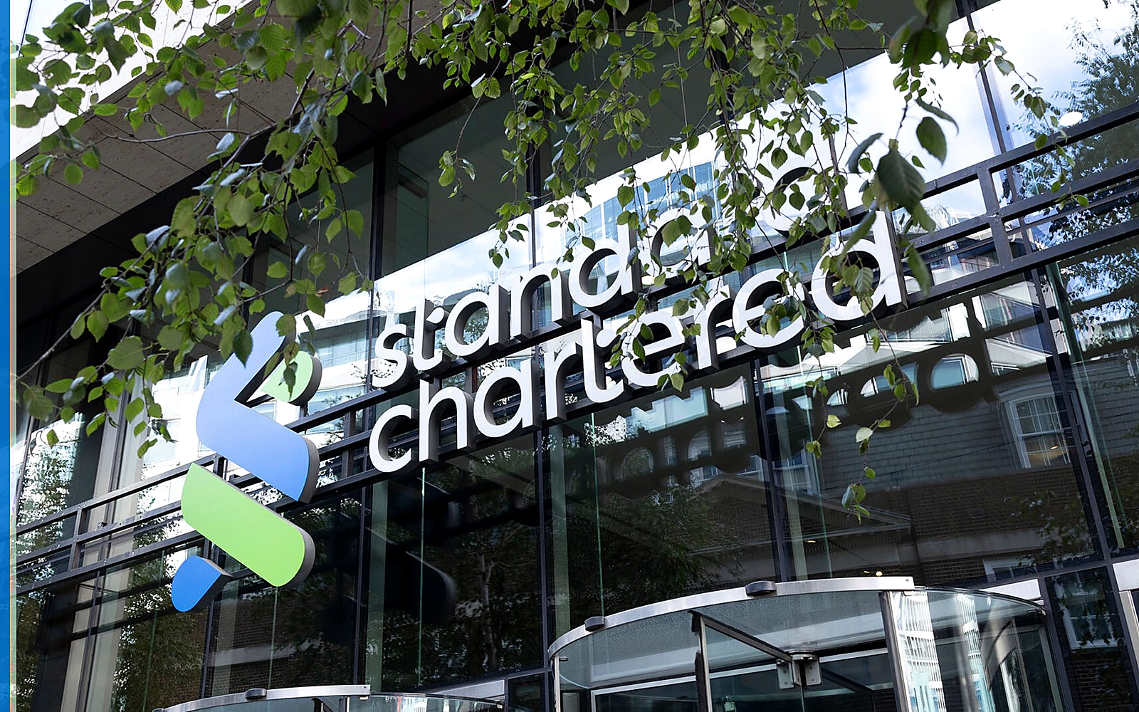 Standard Chartered banking service scene with the source-backed mark in a real-world financial setting.