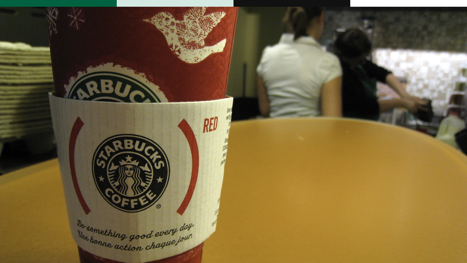 Starbucks seasonal red cup with the siren visible in a store setting.