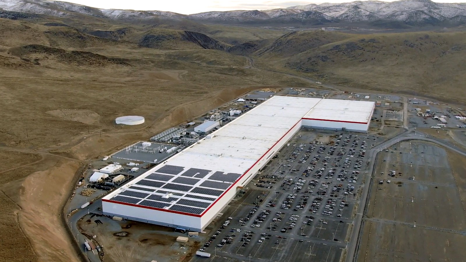 Tesla Gigafactory 1 aerial view with solar panels and industrial scale visible.