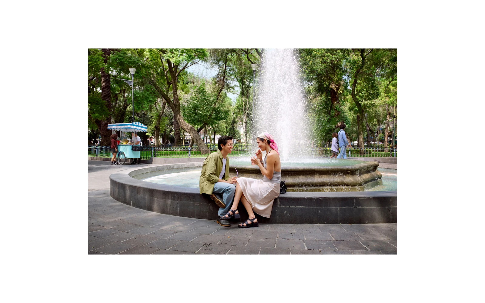 Hinge campaign showing two people talking beside a fountain