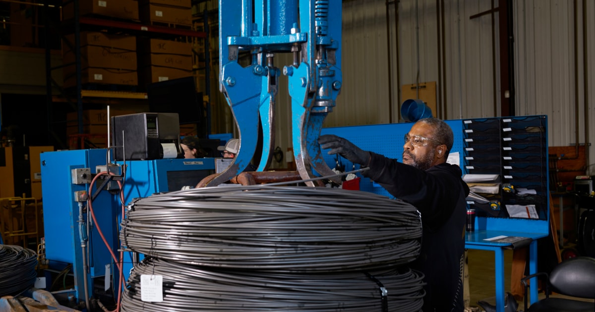 A Perryman Company employee works with raw material at its titanium facility.