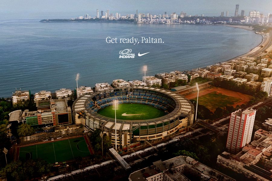 Nike and Mumbai Indians partnership graphic over a view of a Mumbai cricket stadium and waterfront.