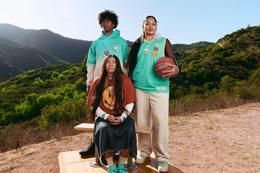 Three athletes wear apparel from the Nike N7 collection designed with Steven Paul Judd.