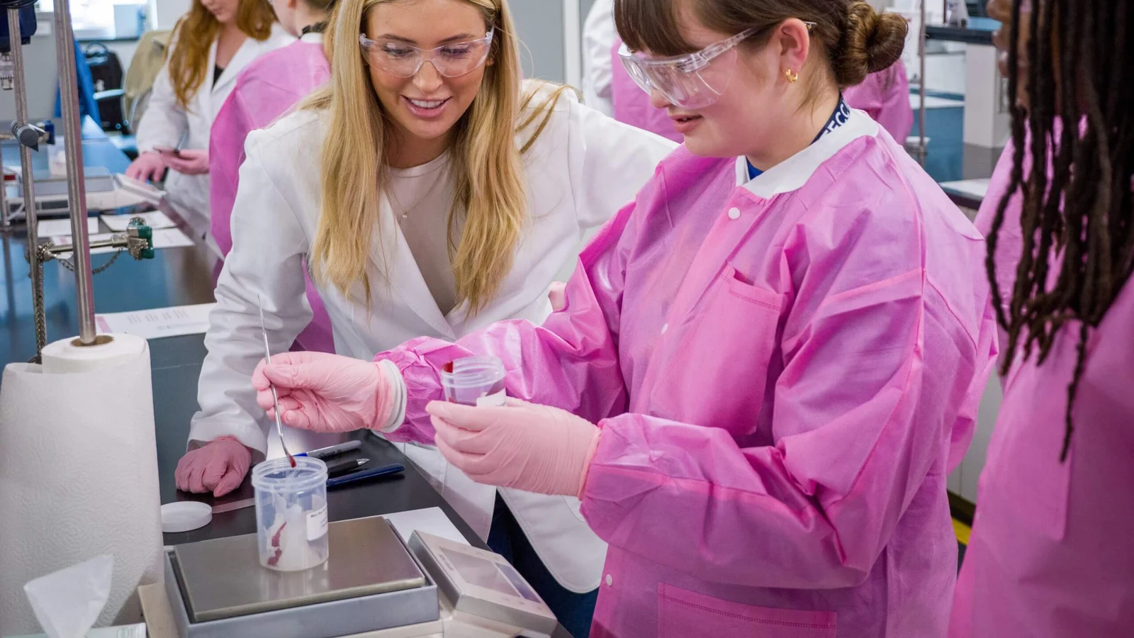 Mary Kay researchers making lip gloss in a laboratory.