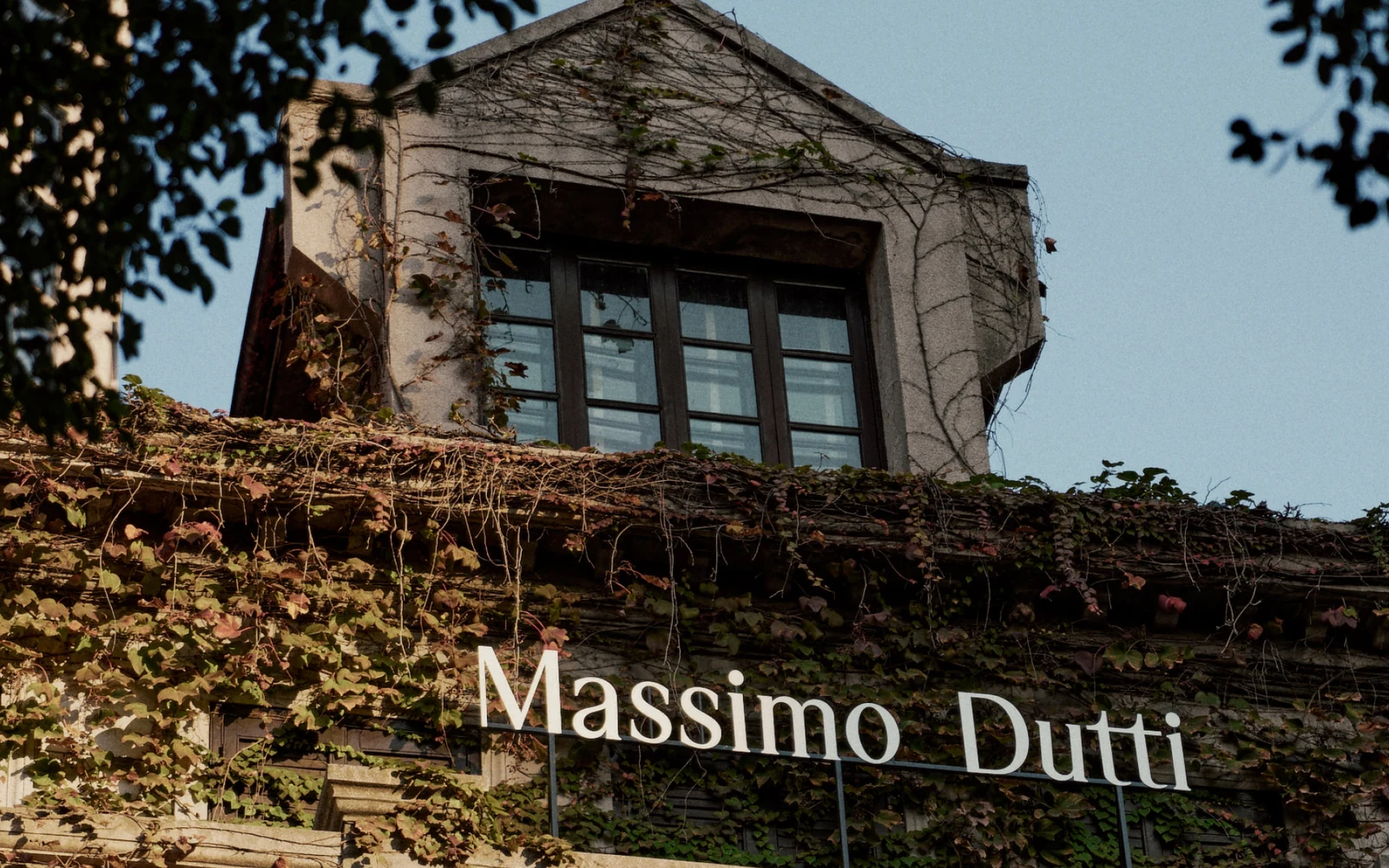 Massimo Dutti sign across a planted historic facade at The Order of Things retail project in Shanghai.