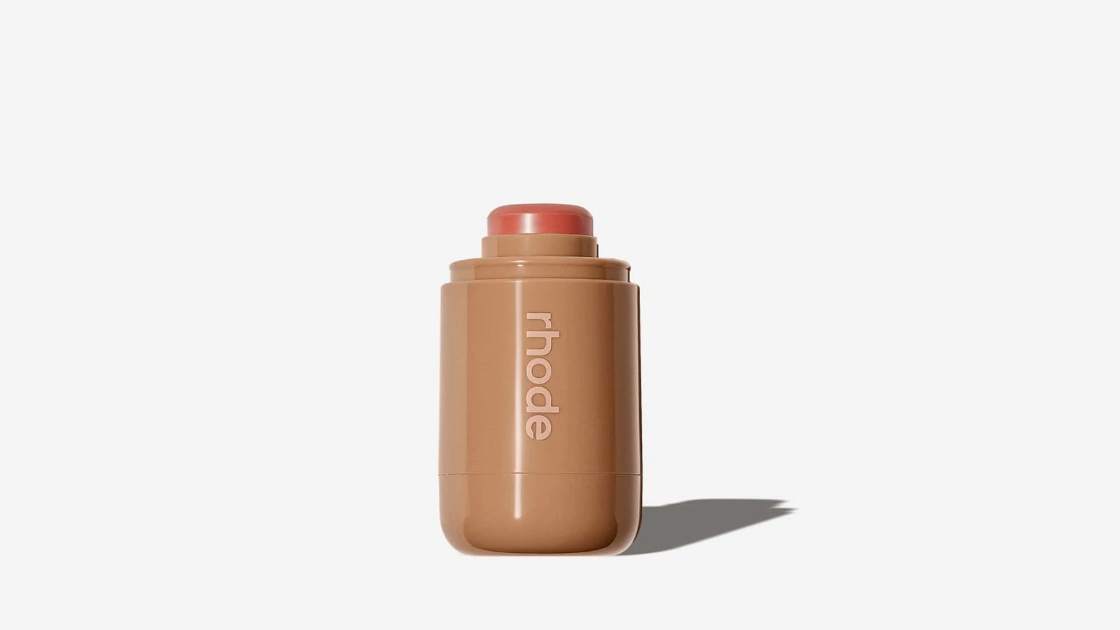 Open Rhode Pocket Blush in the Freckle shade, in a short rounded case with a vertical wordmark.