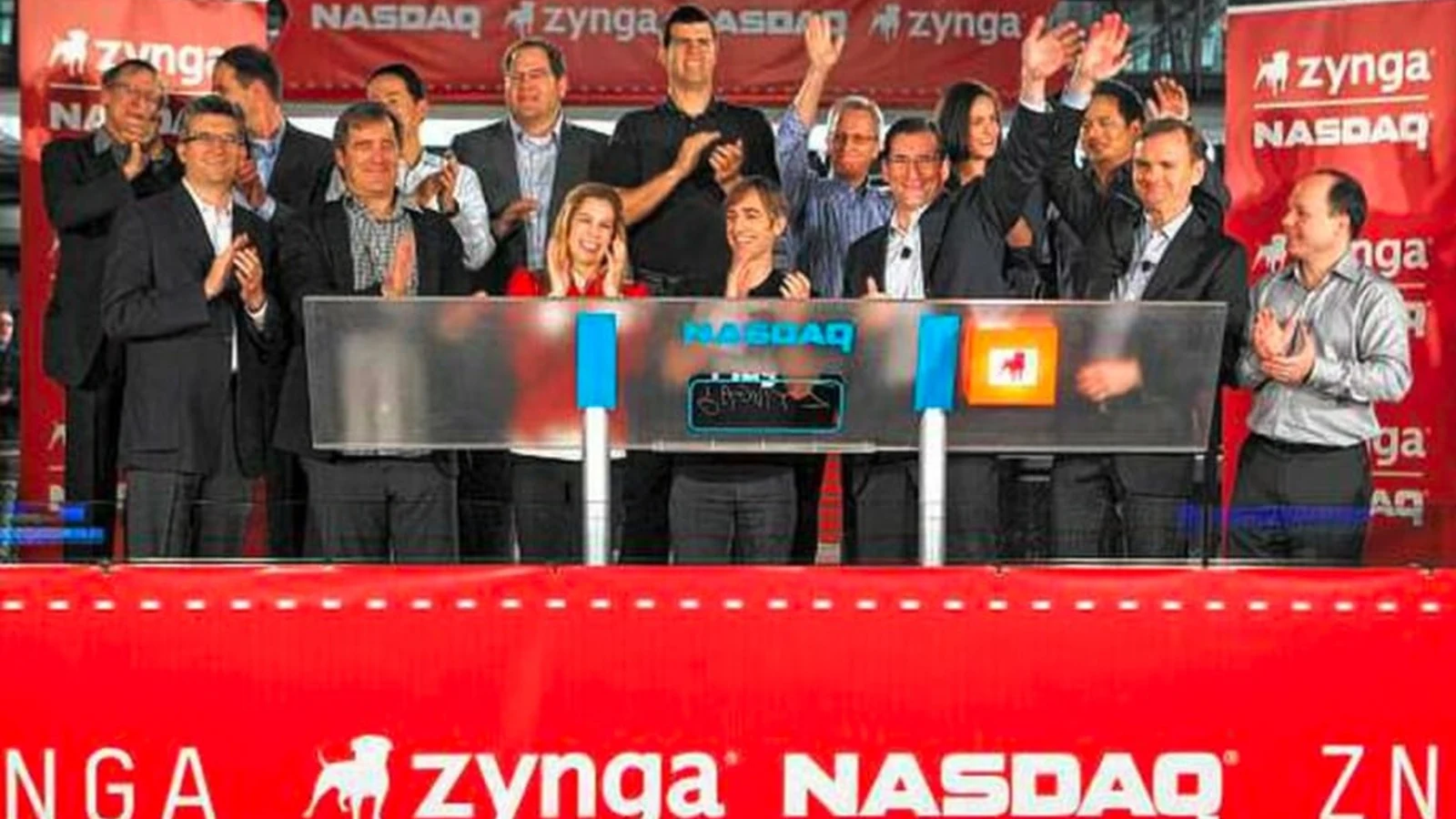 Zynga team members at the Nasdaq opening bell surrounded by red Zynga signage.