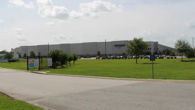 Amazon fulfillment center exterior showing the operating scale behind Prime, marketplace, logistics, and AWS-era brand memory.