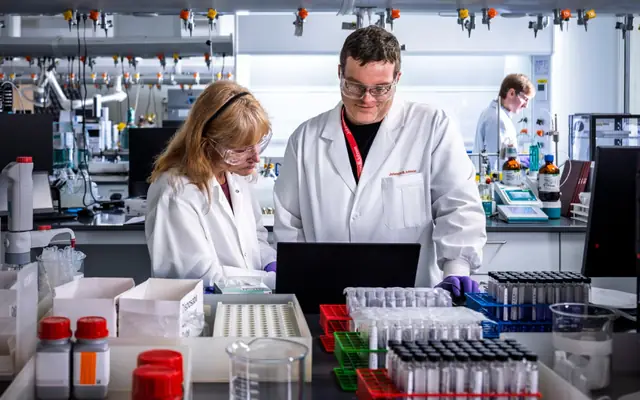 Official Johnson & Johnson laboratory scene with scientists, samples, and medical research proof.
