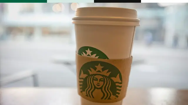 Starbucks cup with the green siren mark visible as a carried brand cue.